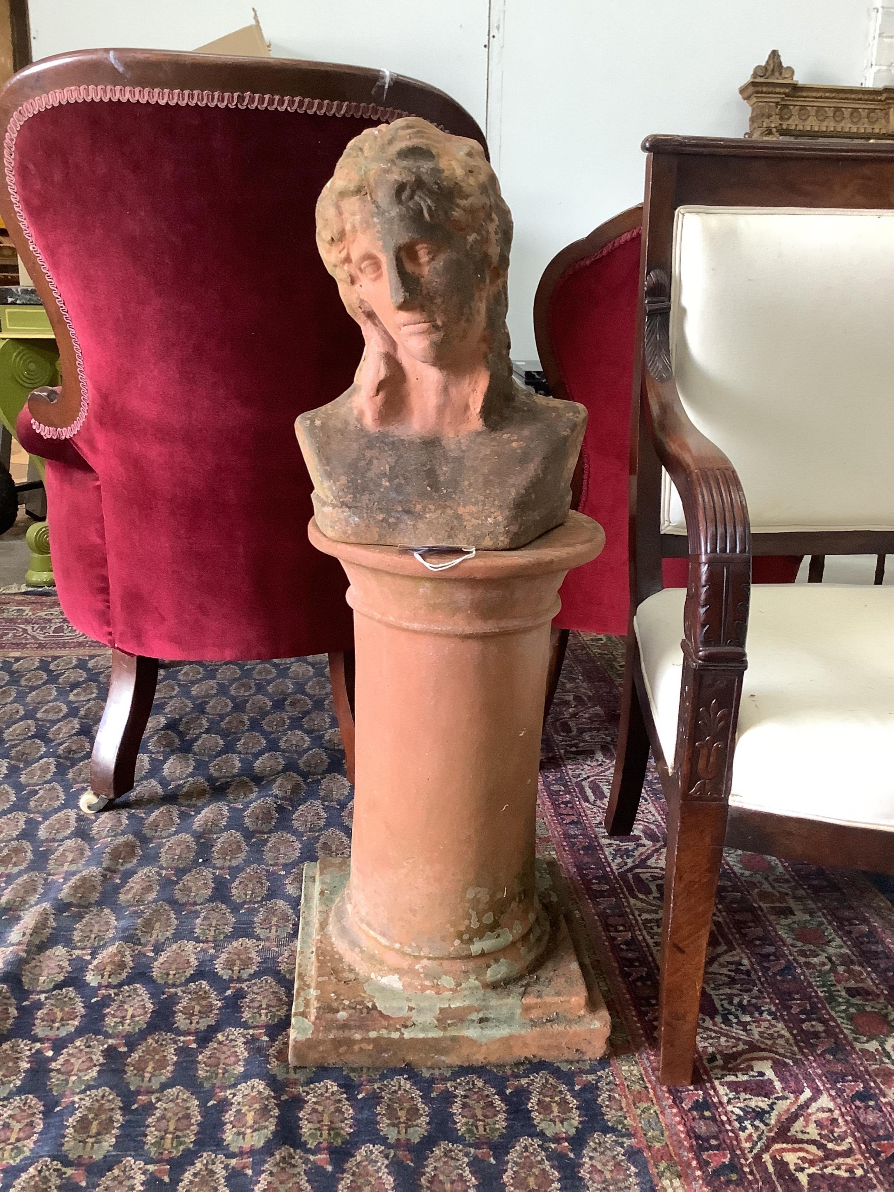 A weathered terracotta garden bust on circular plinth, height 93cm. Condition - fair